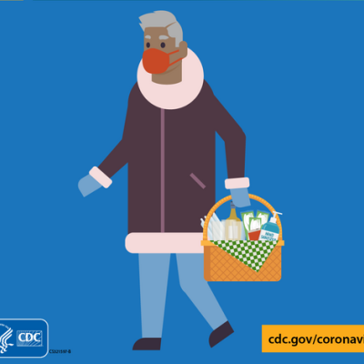person in mask holding a basket of hand sanitizer