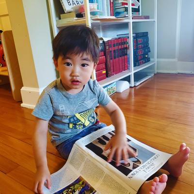 Ray reads a magazine on the floor.