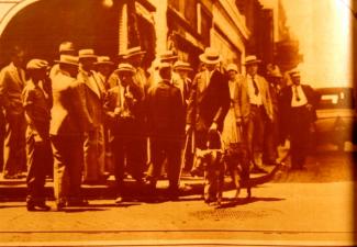 Picture of Morris Frank crossing the street with his guide dog, Buddy.