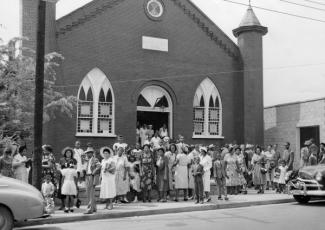 People standing in front of church
